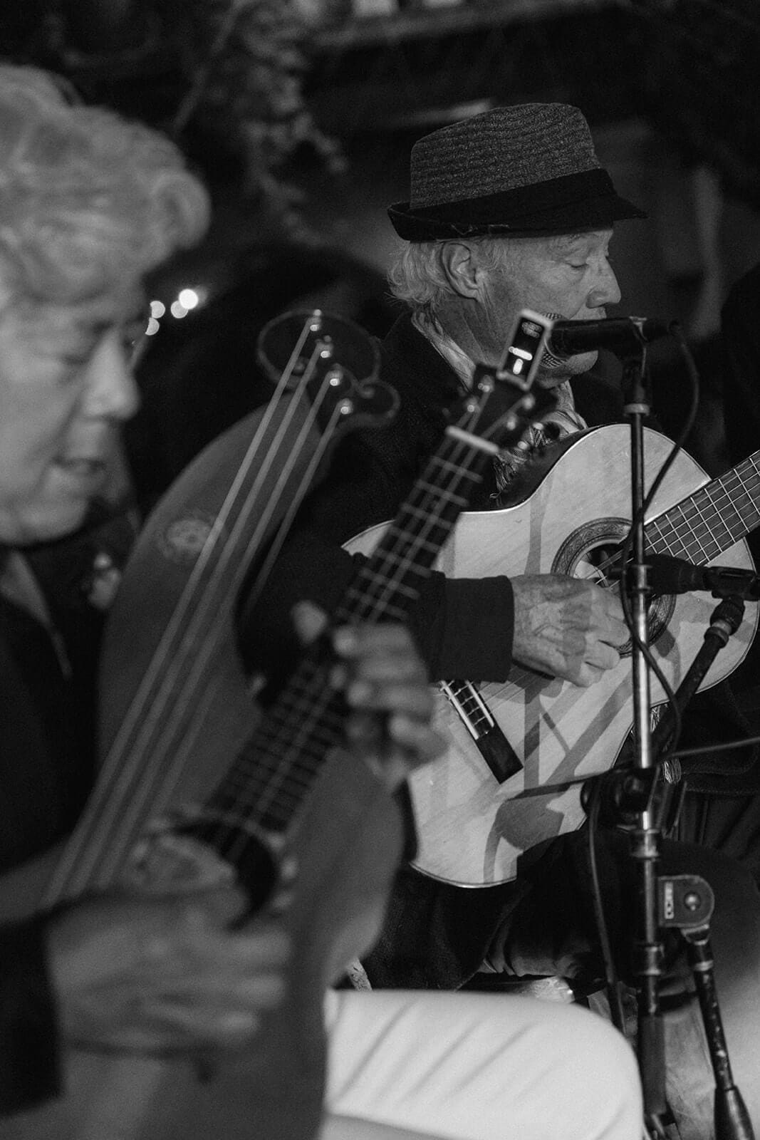Black and white photo of musicians playing instruments during a wedding reception at Tlaquepaque.