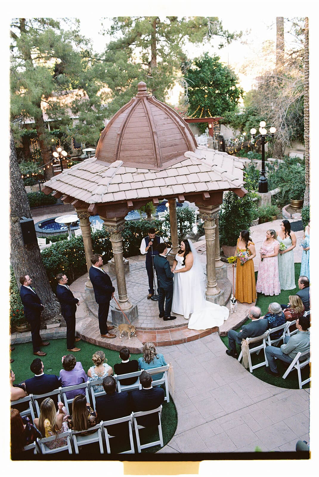 Aerial view of a garden wedding ceremony in progress near the gazebo at The Wright House, a romantic garden wedding venue in Mesa Arizona
