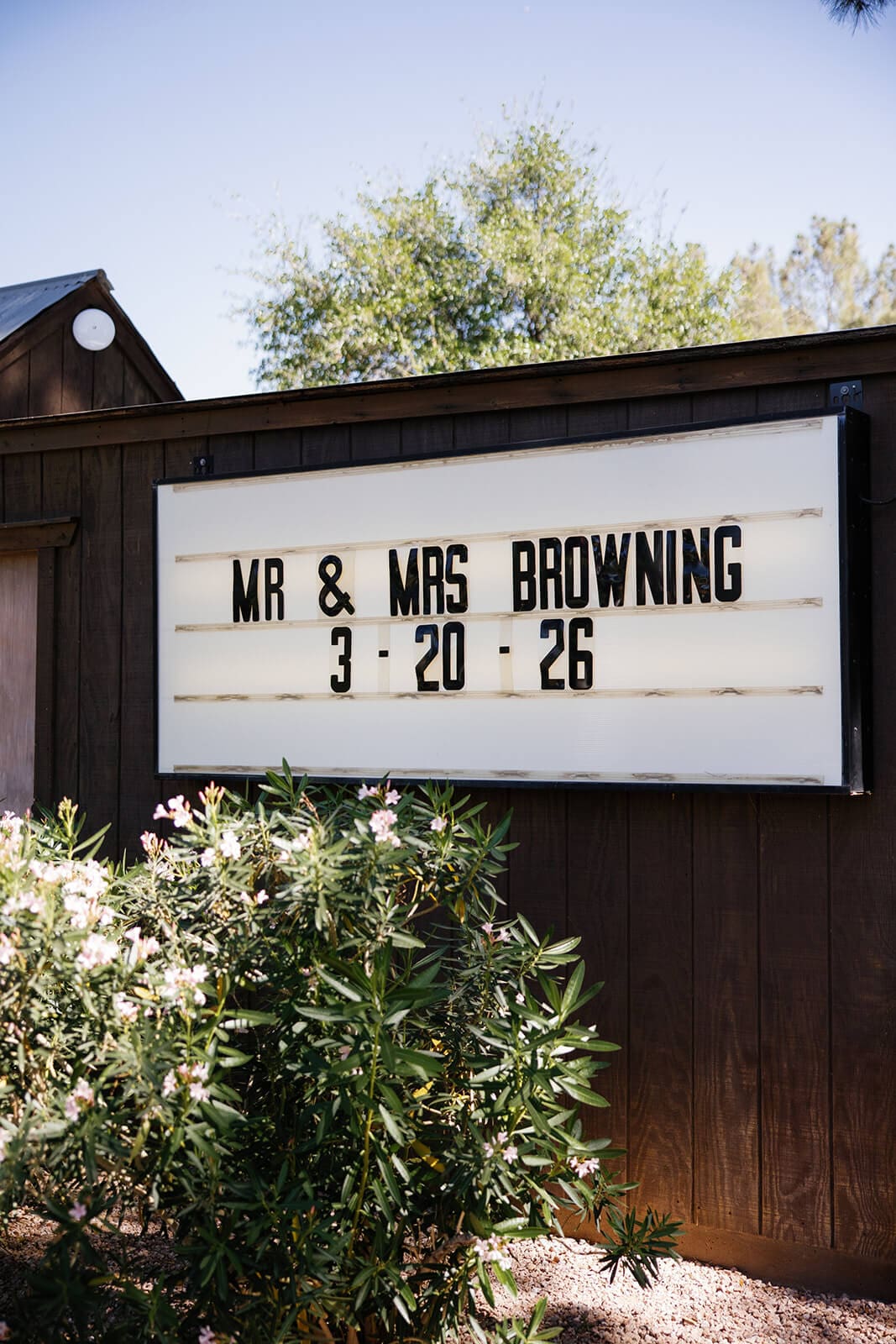 Marquee sign reading Mr and Mrs Browning surrounded by greenery at Shenandoah Mill garden wedding venue in Gilbert Arizona