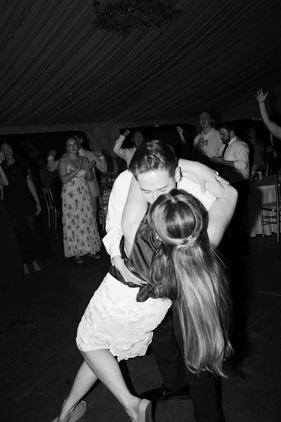 Bride and groom sharing a dramatic dip on the dance floor during their wedding reception at Stonebridge Manor.