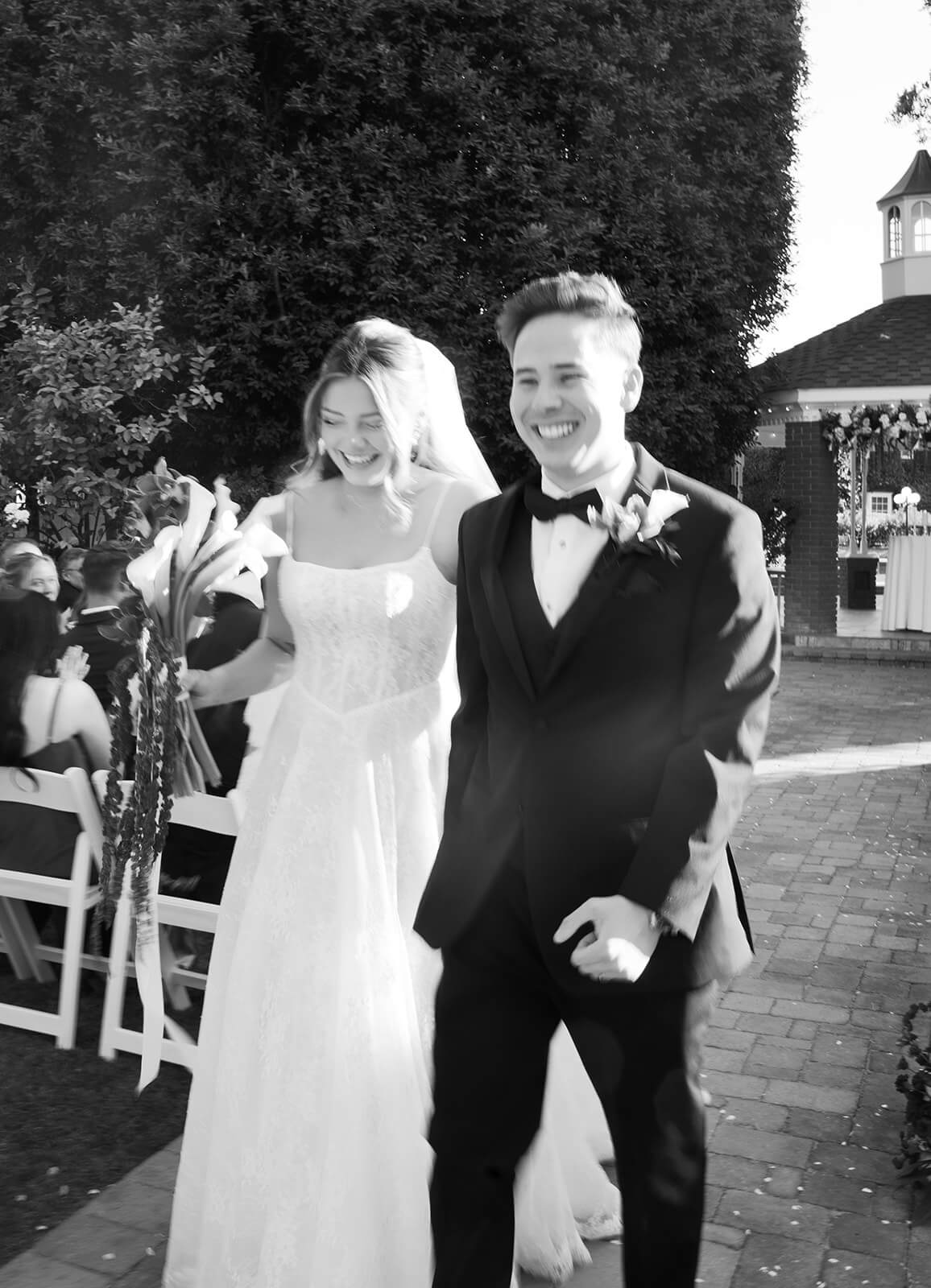 Bride and groom exiting the gazebo ceremony site at Stonebridge Manor after exchanging vows.