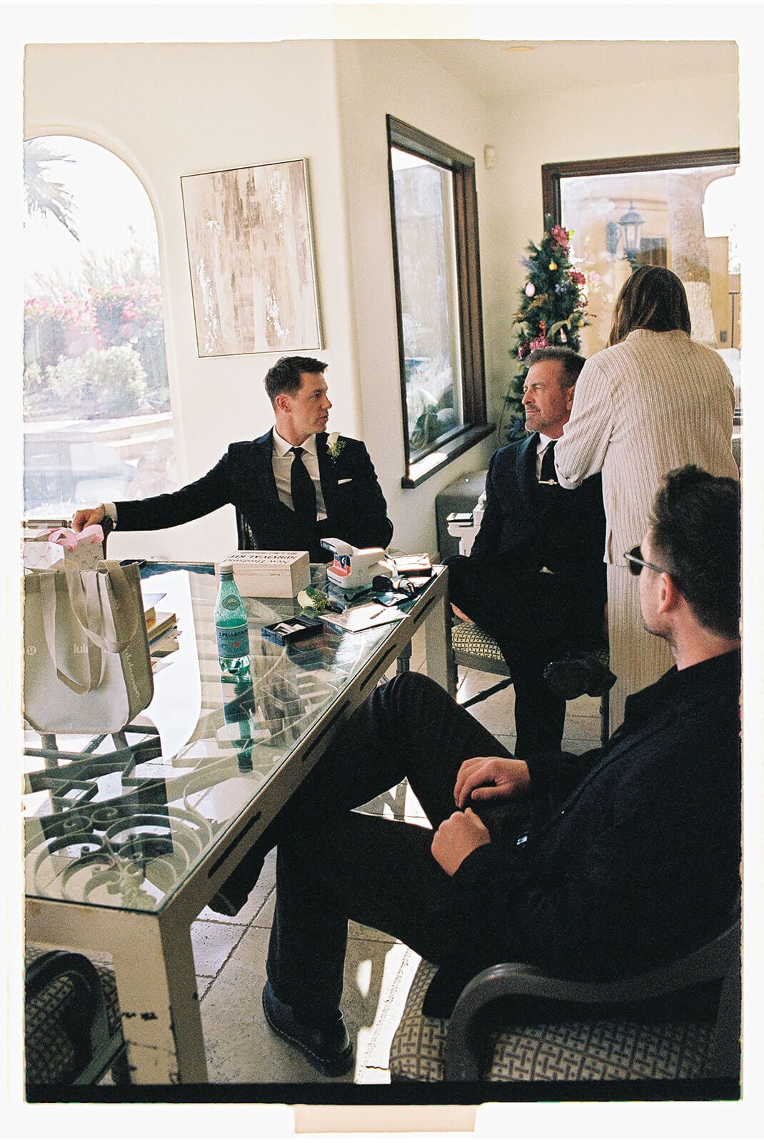 Groom sitting with friends inside the Airbnb before the wedding ceremony begins.