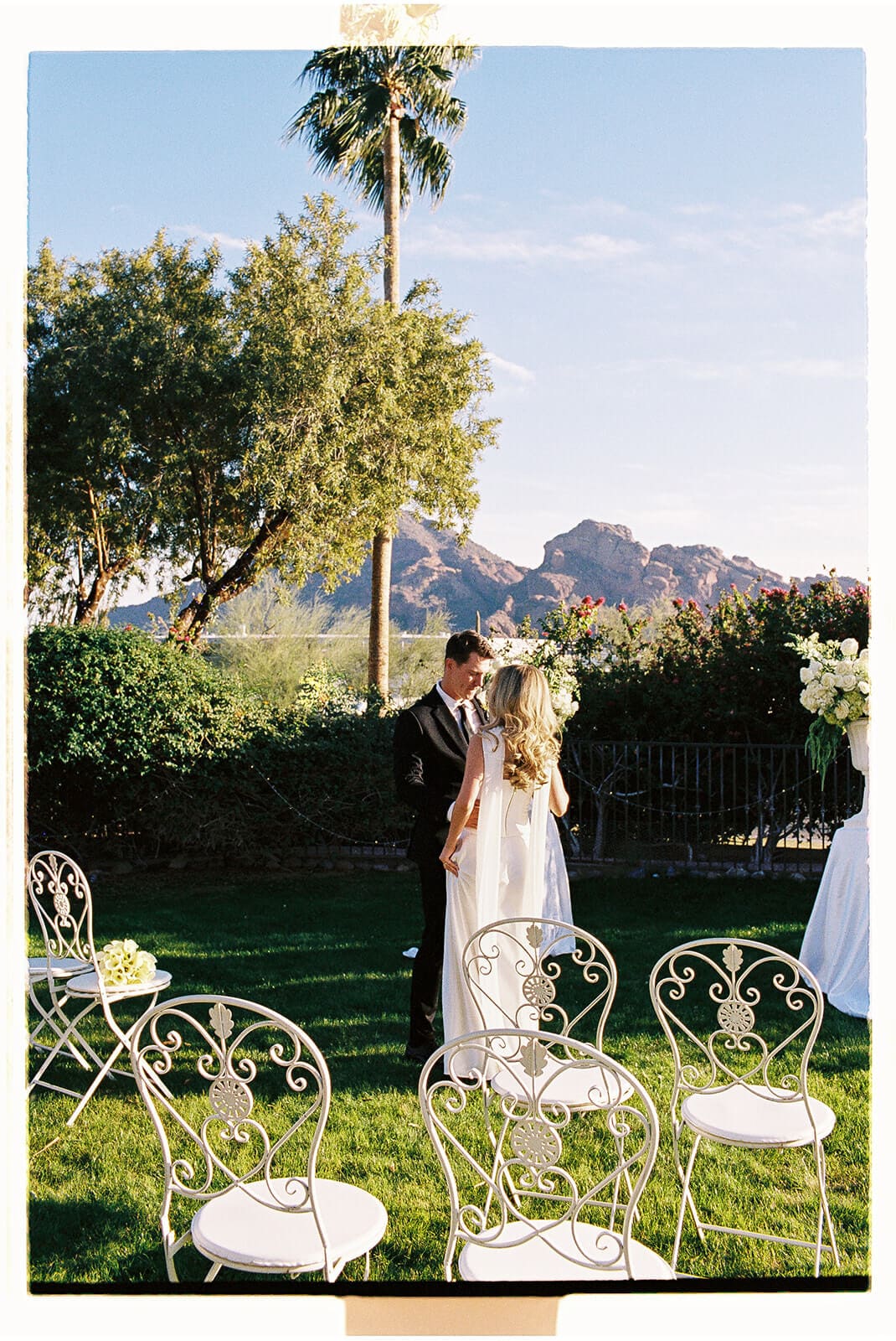 Bride and groom standing together during their outdoor Airbnb wedding ceremony with mountain views.
