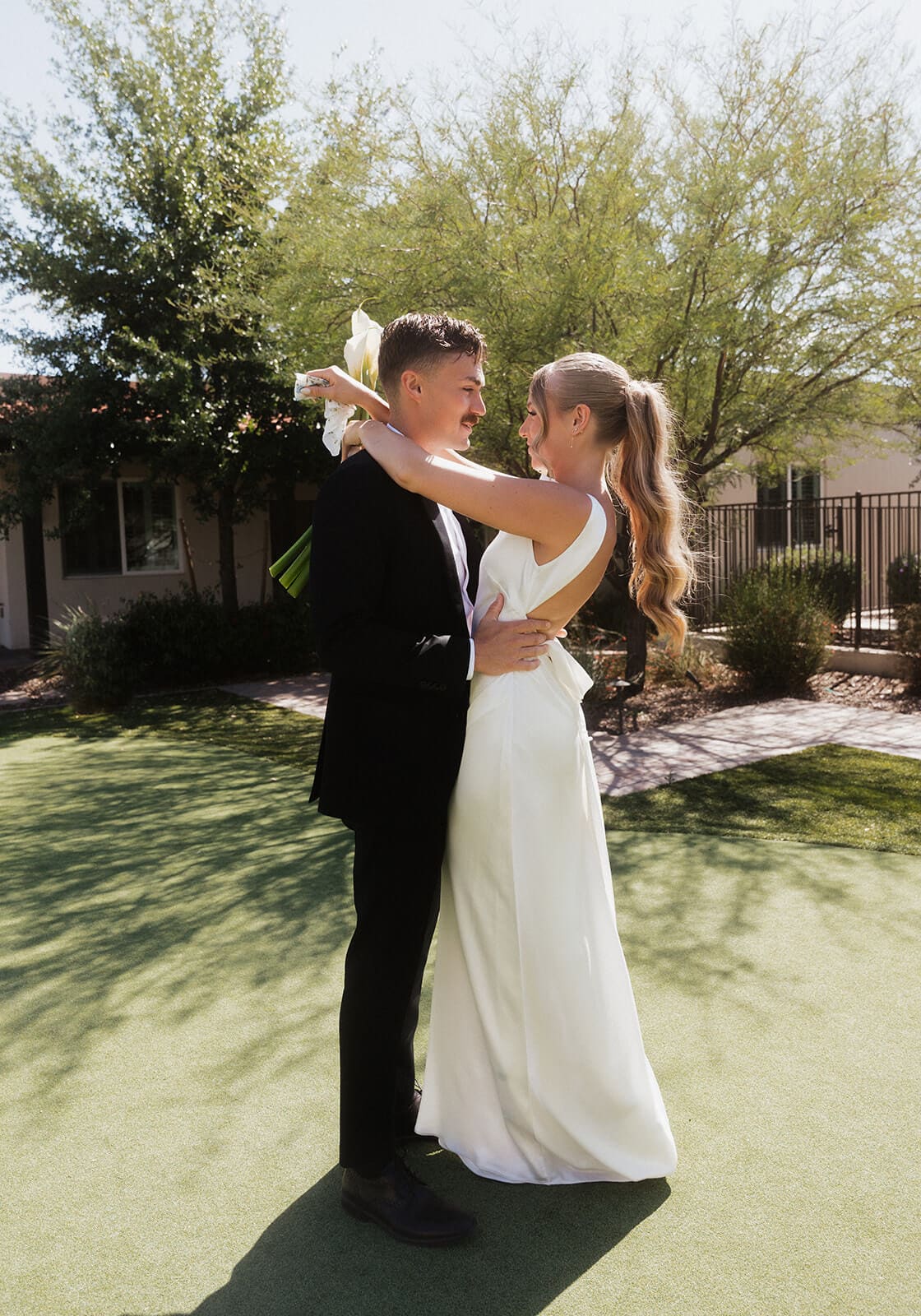 Bride and groom sharing a first dance during their intimate Airbnb wedding celebration on the lawn.
